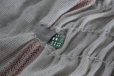 The electronics can be placed in the pocket to make a connection with the sensor yarn in the back of the pocket